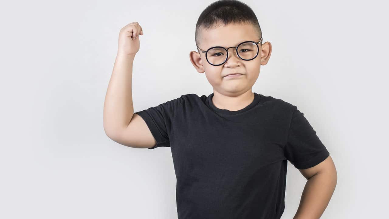 petit garçon montrant ses muscles